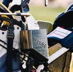 Scrubi golf club cleaner attached to a golf bag, featuring durable bristles for effective club cleaning on the course.