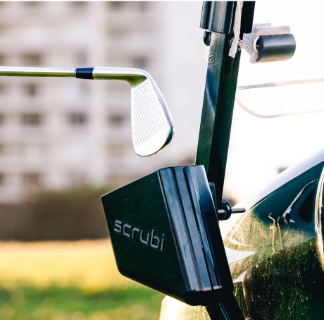 Scrubi golf club cleaner attached to a golf cart, featuring durable bristles for effective club cleaning on the course