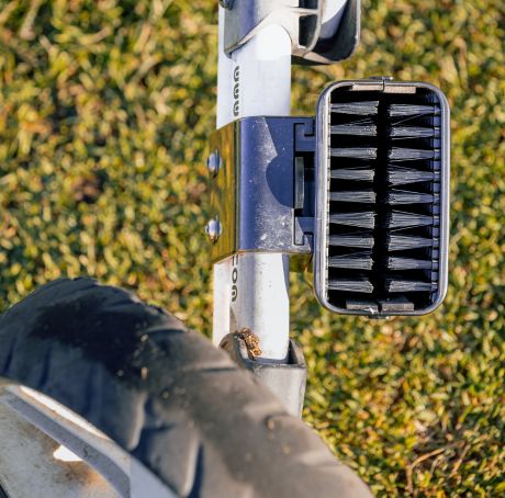 Scrubi golf club cleaner attached to a 3-wheel Clicgear, featuring durable bristles for effective club cleaning on the course.