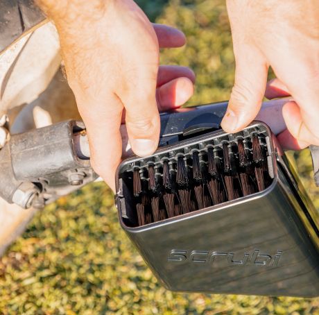 Scrubi golf club cleaner attached to a 3-wheel Clicgear, featuring durable bristles for effective club cleaning on the course.