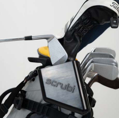 Scrubi golf club cleaner attached to a golf bag, featuring durable bristles for effective club cleaning on the course.
